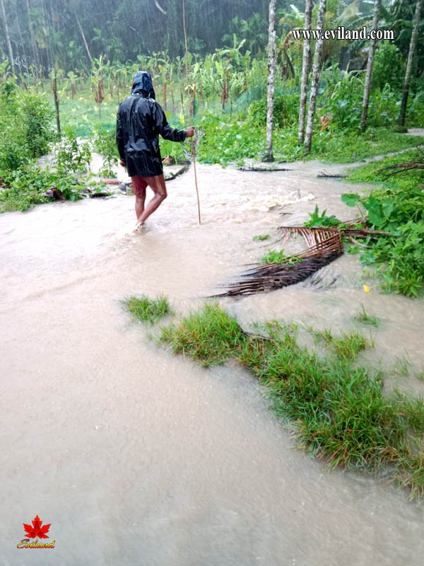 Man crossing bridge in flood